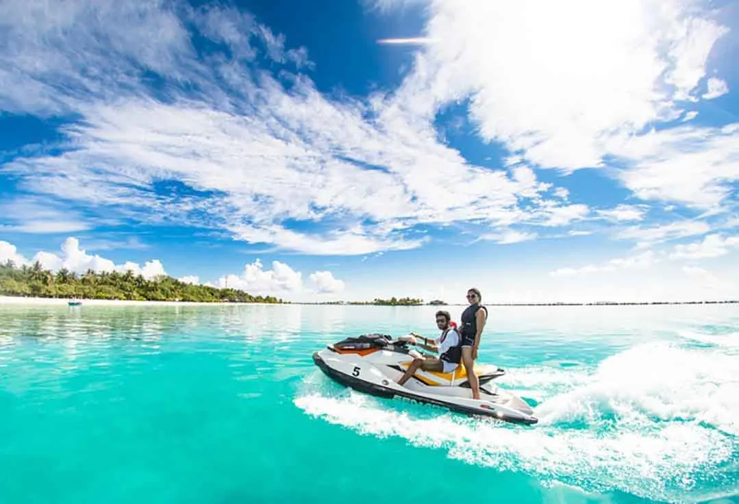Key West Party Boat Jet Ski rental couple cruises through tropical water.