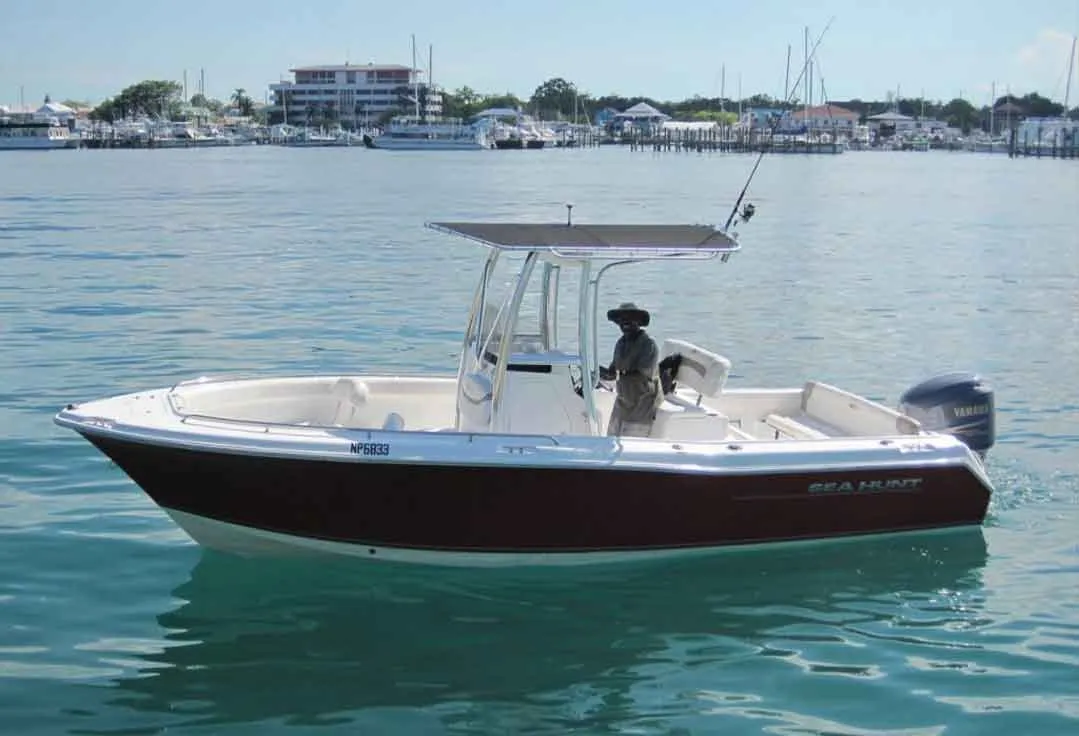 A center console with Key West Boat Rentals sits still in the water.