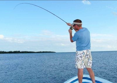 man fly fishes on flats with key west fishing charters