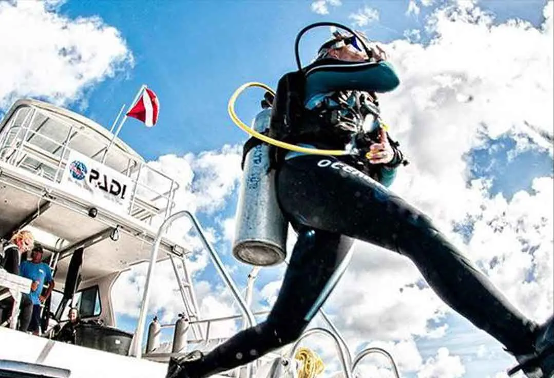 Guy takes a giant stride into the water with Key West Scuba Diving