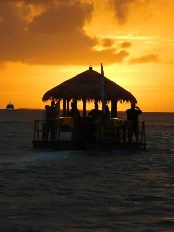 Floating tiki bar boat motors during a Key West Sunset Cruise