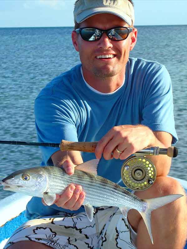 man holding a bonefish with key west flats fishing