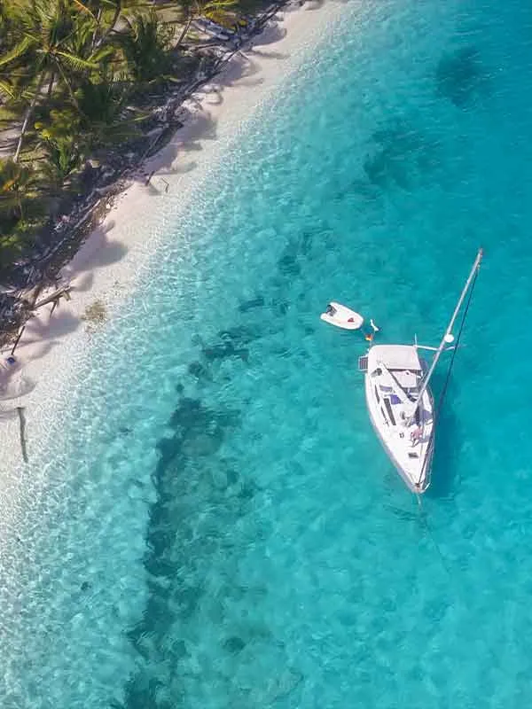 Sailboat hangs out with on private beach with Key West Private Charter Boats