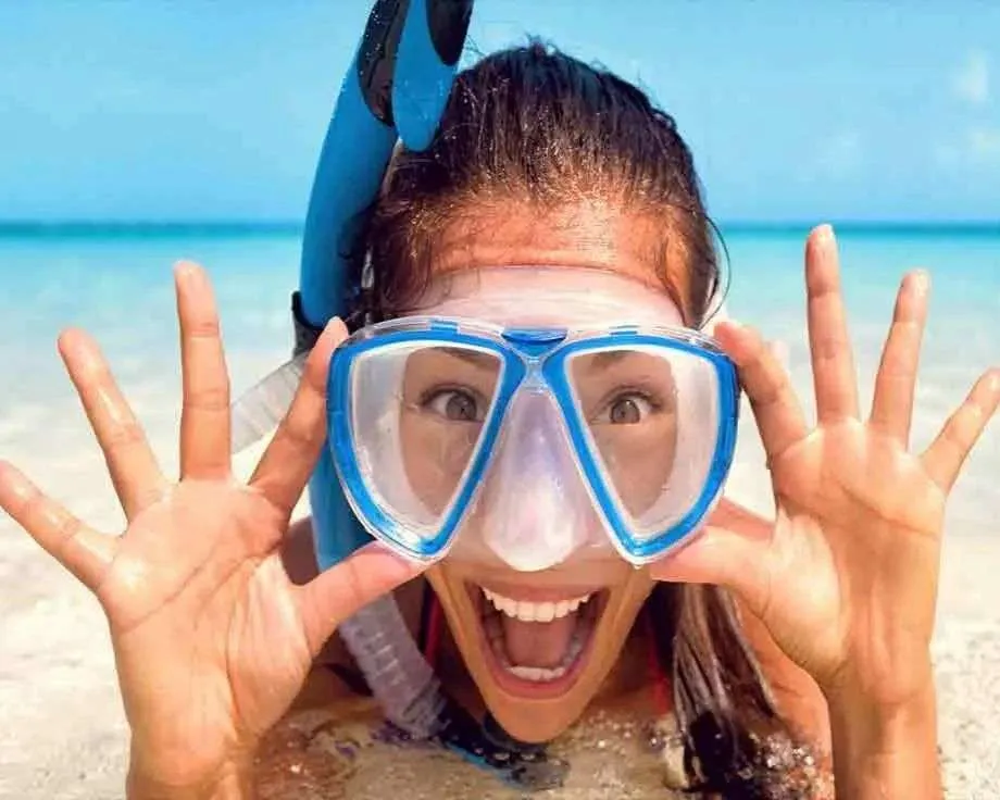 Girl on beach snorkels during a Stay on a boat in Key West trip.